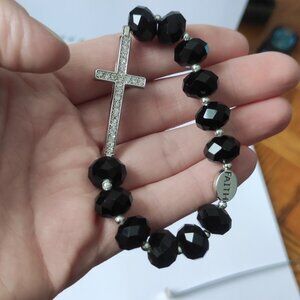 bracelet with black faceted beads, a silver cross with the inscription 'FAITH'